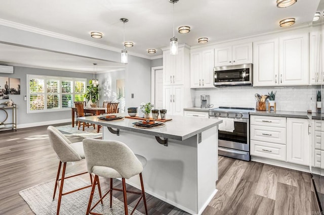 1670 Alta Vista Dr, Vista, CA 92084 - kitchen featuring appliances with stainless steel finishes, white cabinets, backsplash, a kitchen bar, and ornamental molding
