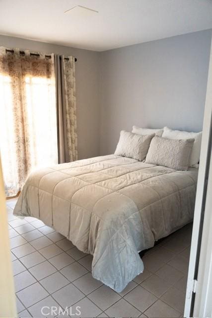 3223 Algonquin Ln, Riverside, CA 92503 - bedroom featuring multiple windows and light tile patterned flooring