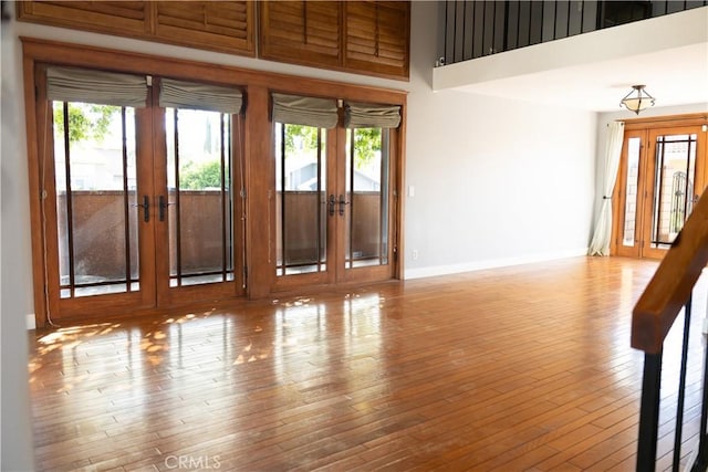 3223 Algonquin Ln, Riverside, CA 92503 - spare room featuring french doors, plenty of natural light, hardwood / wood-style floors, and a high ceiling