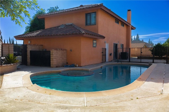 3223 Algonquin Ln, Riverside, CA 92503 - view of swimming pool with a gate and a pool with connected hot tub