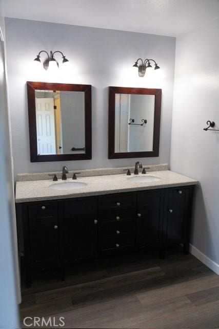 3223 Algonquin Ln, Riverside, CA 92503 - full bathroom featuring wood finished floors and double vanity
