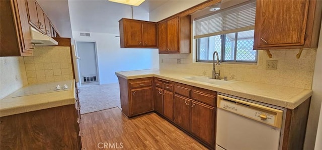 28218 W Worcester Rd, Menifee, CA 92586 - kitchen with white dishwasher, under cabinet range hood, light wood-style flooring, decorative backsplash, and brown cabinetry
