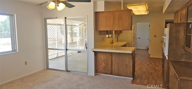 28218 W Worcester Rd, Menifee, CA 92586 - kitchen with brown cabinetry, ceiling fan, and plenty of natural light