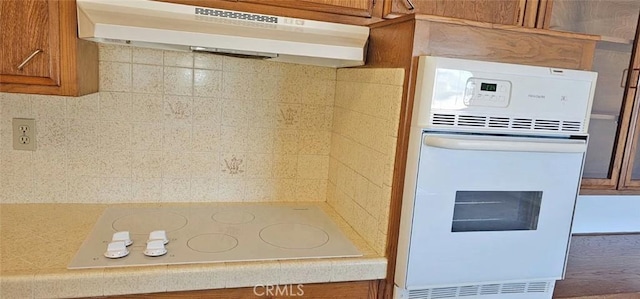 28218 W Worcester Rd, Menifee, CA 92586 - kitchen with under cabinet range hood, white appliances, and brown cabinets