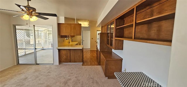 28218 W Worcester Rd, Menifee, CA 92586 - kitchen with brown cabinets, ceiling fan, carpet flooring, and open shelves