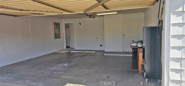 28218 W Worcester Rd, Menifee, CA 92586 - garage featuring freestanding refrigerator and a garage door opener