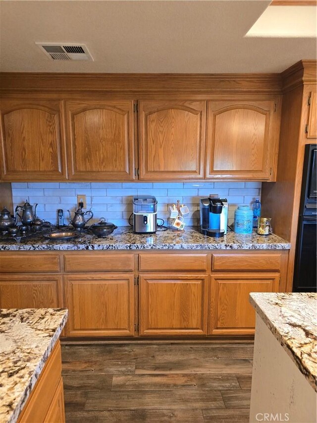 41653 62nd St W, Palmdale, CA 93551 - kitchen with tasteful backsplash, light stone counters, and dark wood finished floors