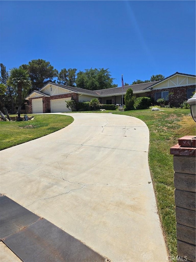 41653 62nd St W, Palmdale, CA 93551 - ranch-style home featuring curved driveway, a front lawn, and an attached garage