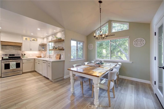 6362 Coffeeberry Ct, Avila Beach, CA 93424 - dining space with vaulted ceiling, a chandelier, and light wood finished floors