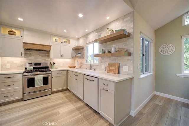 6362 Coffeeberry Ct, Avila Beach, CA 93424 - kitchen featuring stainless steel gas range oven, dishwashing machine, open shelves, light wood-style flooring, and decorative backsplash