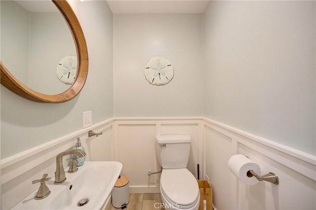 6362 Coffeeberry Ct, Avila Beach, CA 93424 - bathroom with a decorative wall, a wainscoted wall, and wood finished floors