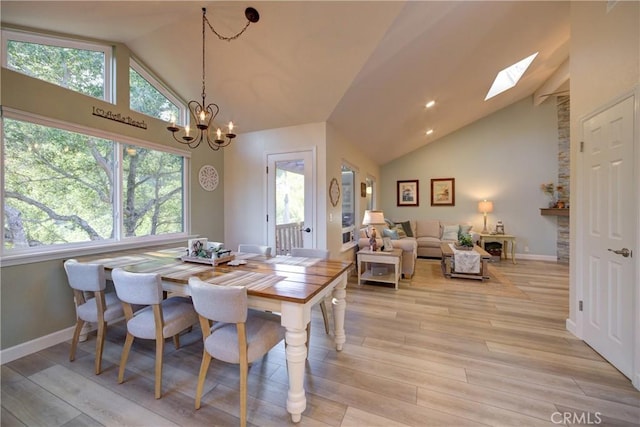 6362 Coffeeberry Ct, Avila Beach, CA 93424 - dining area with high vaulted ceiling, light wood-type flooring, and a chandelier