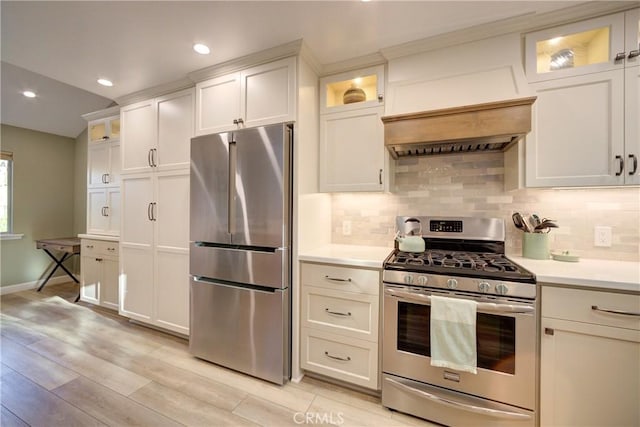 6362 Coffeeberry Ct, Avila Beach, CA 93424 - kitchen with stainless steel appliances, light countertops, tasteful backsplash, light wood-style floors, and custom exhaust hood