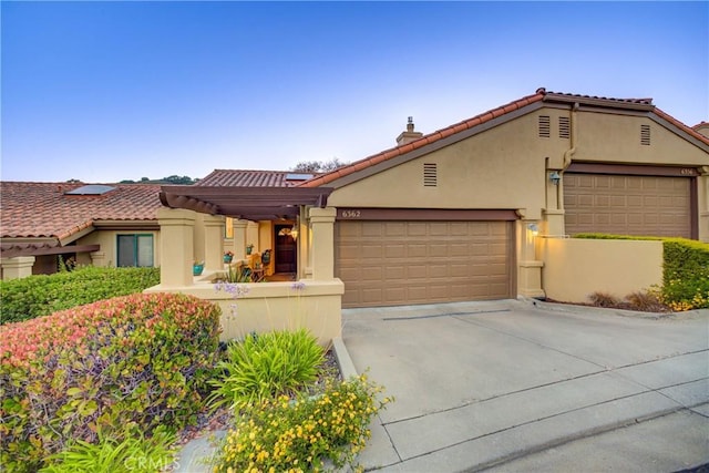 6362 Coffeeberry Ct, Avila Beach, CA 93424 - mediterranean / spanish home featuring stucco siding, concrete driveway, an attached garage, and a tiled roof