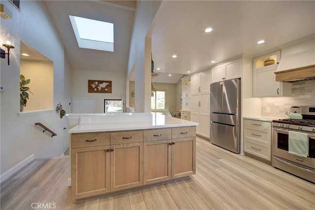 6362 Coffeeberry Ct, Avila Beach, CA 93424 - kitchen featuring stainless steel appliances, a skylight, light wood-style flooring, light countertops, and tasteful backsplash