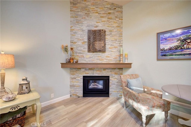 6362 Coffeeberry Ct, Avila Beach, CA 93424 - living area with wood finished floors, a stone fireplace, and vaulted ceiling