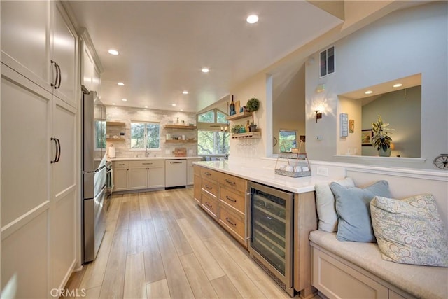 6362 Coffeeberry Ct, Avila Beach, CA 93424 - kitchen with wine cooler, open shelves, white dishwasher, recessed lighting, and tasteful backsplash