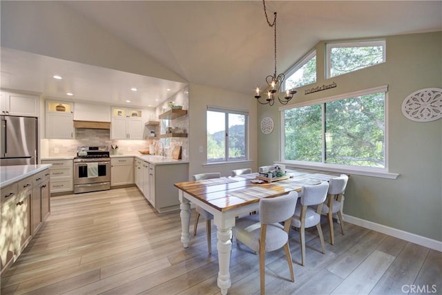 6362 Coffeeberry Ct, Avila Beach, CA 93424 - dining area featuring plenty of natural light, a chandelier, light wood-style floors, high vaulted ceiling, and recessed lighting