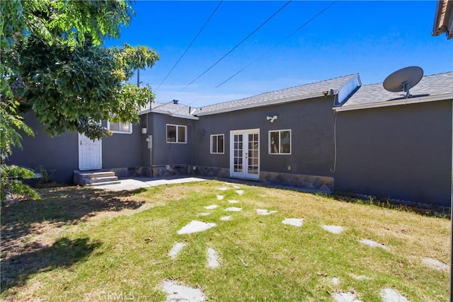 5609 Clark Ave, Lakewood, CA 90712 - rear view of property featuring french doors, a lawn, and stucco siding
