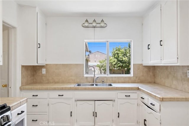5609 Clark Ave, Lakewood, CA 90712 - kitchen featuring white cabinetry, backsplash, and tile counters