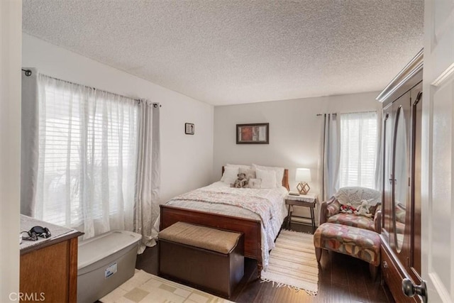 1490 Cabrillo Park Dr Unit B, Santa Ana, CA 92701 - bedroom with a textured ceiling and wood finished floors