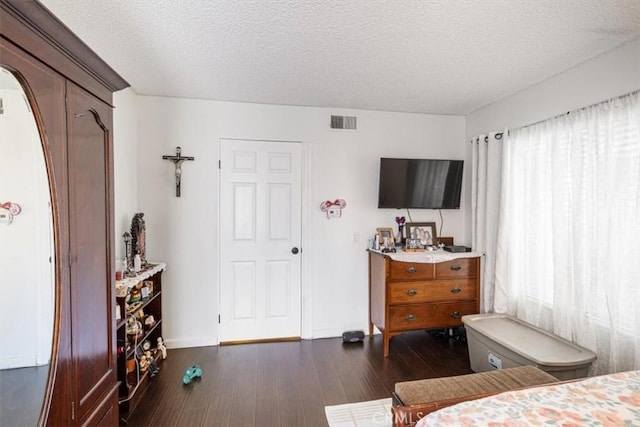 1490 Cabrillo Park Dr Unit B, Santa Ana, CA 92701 - bedroom featuring dark wood-style flooring, a textured ceiling, and arched walkways