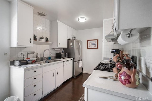 1490 Cabrillo Park Dr Unit B, Santa Ana, CA 92701 - kitchen featuring stainless steel appliances, decorative backsplash, dark wood-style flooring, light countertops, and white cabinetry