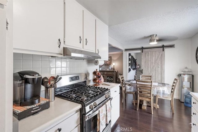 1490 Cabrillo Park Dr Unit B, Santa Ana, CA 92701 - kitchen with stainless steel gas stove, under cabinet range hood, a barn door, light countertops, and backsplash