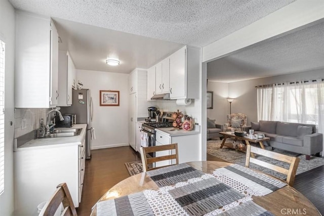 1490 Cabrillo Park Dr Unit B, Santa Ana, CA 92701 - kitchen with stainless steel range with gas cooktop, a textured ceiling, tasteful backsplash, light countertops, and white cabinetry