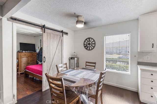 1490 Cabrillo Park Dr Unit B, Santa Ana, CA 92701 - dining space with a barn door, dark wood-type flooring, and a textured ceiling
