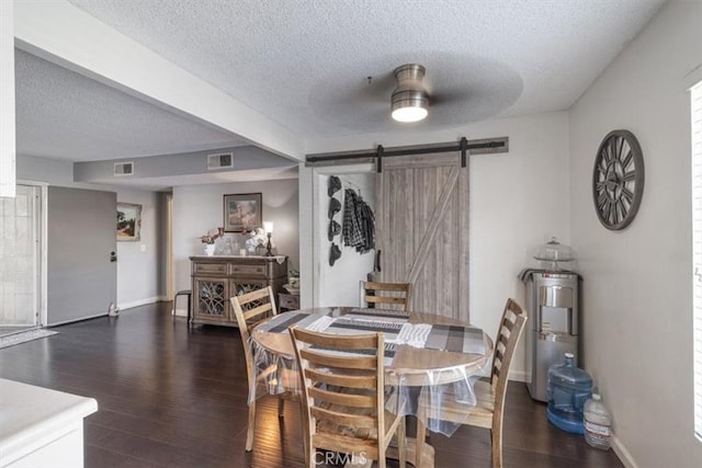 1490 Cabrillo Park Dr Unit B, Santa Ana, CA 92701 - dining space featuring a textured ceiling, dark wood-style floors, and a barn door