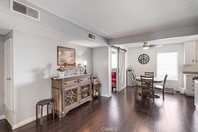 1490 Cabrillo Park Dr Unit B, Santa Ana, CA 92701 - dining room featuring a barn door, a textured ceiling, dark wood finished floors, and ceiling fan