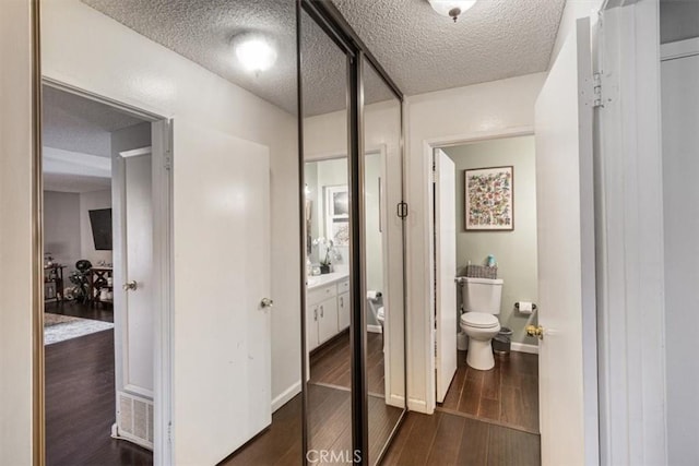 1490 Cabrillo Park Dr Unit B, Santa Ana, CA 92701 - bathroom with a textured ceiling, wood finished floors, and vanity