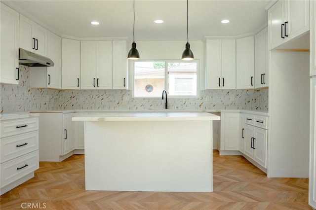 5916 Walnut Ave, Long Beach, CA 90805 - kitchen featuring under cabinet range hood, decorative backsplash, a center island, hanging light fixtures, and recessed lighting