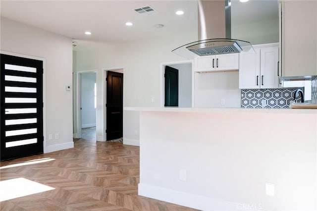 5916 Walnut Ave, Long Beach, CA 90805 - kitchen with island range hood, white cabinets, recessed lighting, light countertops, and a peninsula