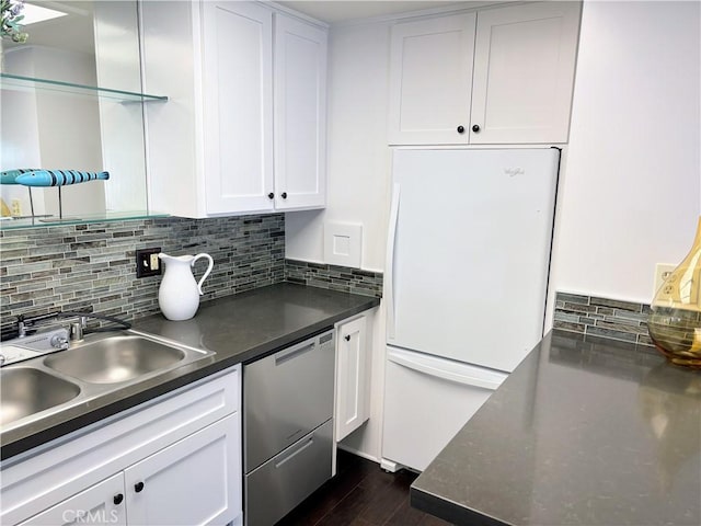 13310 N Fairfield Ln Unit M7 176L, Seal Beach, CA 90740 - kitchen with freestanding refrigerator, stainless steel dishwasher, white cabinetry, and backsplash