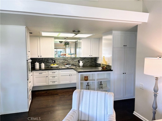 13310 N Fairfield Ln Unit M7 176L, Seal Beach, CA 90740 - kitchen featuring dark countertops, dark wood-style flooring, open shelves, and decorative backsplash