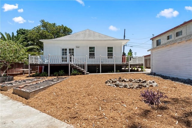 976 N Loma Vista Dr, Long Beach, CA 90813 - back of property featuring a vegetable garden, a wooden deck, and stairs