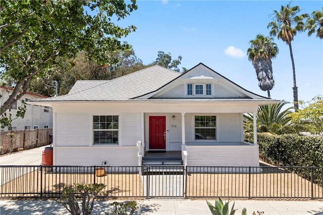 976 N Loma Vista Dr, Long Beach, CA 90813 - bungalow featuring a fenced front yard and roof with shingles
