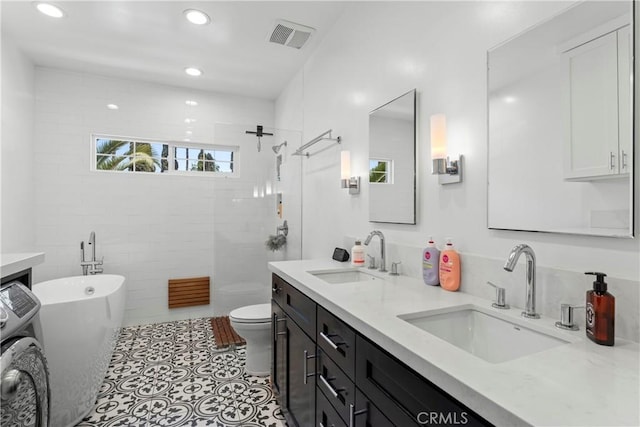 976 N Loma Vista Dr, Long Beach, CA 90813 - bathroom with washer / clothes dryer, double vanity, a freestanding tub, a walk in shower, and recessed lighting