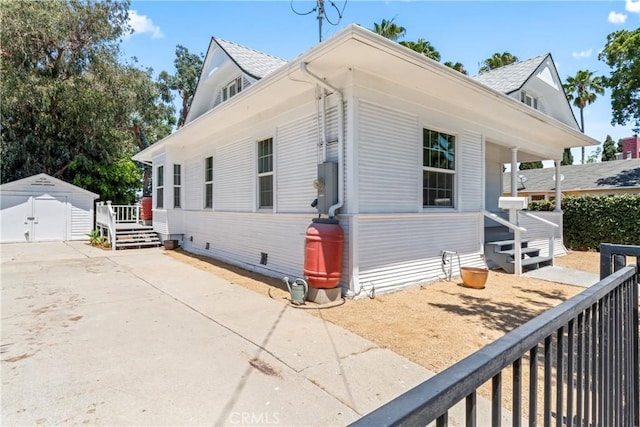 976 N Loma Vista Dr, Long Beach, CA 90813 - view of front facade featuring a storage unit and roof with shingles