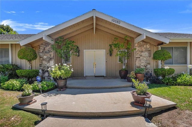 10020 Wystone Ave, Northridge, CA 91324 - view of exterior entry featuring stone siding, roof with shingles, and board and batten siding