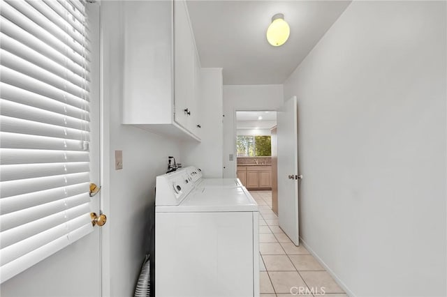10020 Wystone Ave, Northridge, CA 91324 - laundry area with washer and clothes dryer, light tile patterned flooring, and cabinet space