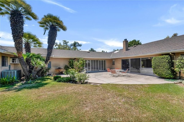 10020 Wystone Ave, Northridge, CA 91324 - back of house featuring a chimney, a yard, a patio area, and stucco siding
