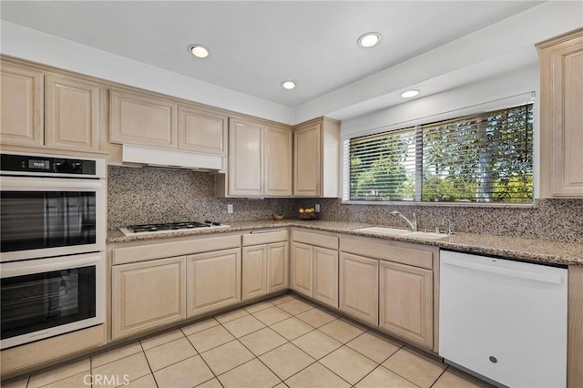 10020 Wystone Ave, Northridge, CA 91324 - kitchen with white appliances, light brown cabinetry, under cabinet range hood, light tile patterned floors, and decorative backsplash