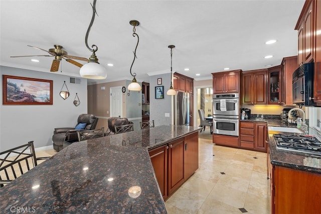 24682 Via Tequila, Lake Forest, CA 92630 - kitchen featuring appliances with stainless steel finishes, crown molding, a ceiling fan, recessed lighting, and dark stone countertops