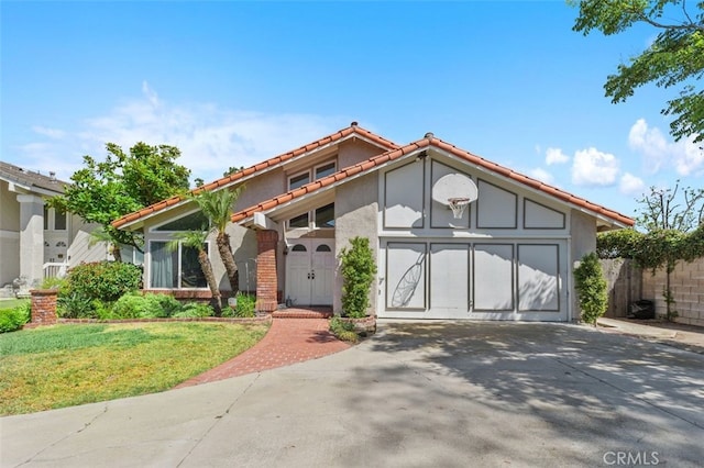 24682 Via Tequila, Lake Forest, CA 92630 - mediterranean / spanish-style home with concrete driveway, a tile roof, stucco siding, and a garage