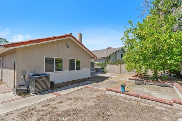 24682 Via Tequila, Lake Forest, CA 92630 - rear view of house with stucco siding, a patio area, and a chimney