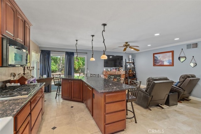 24682 Via Tequila, Lake Forest, CA 92630 - kitchen with a breakfast bar area, stainless steel gas cooktop, crown molding, a ceiling fan, and open floor plan