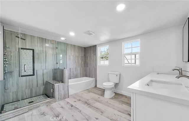 11912 Arthur Dr, Anaheim, CA 92804 - full bathroom with a freestanding bath, a stall shower, double vanity, recessed lighting, and wood finished floors